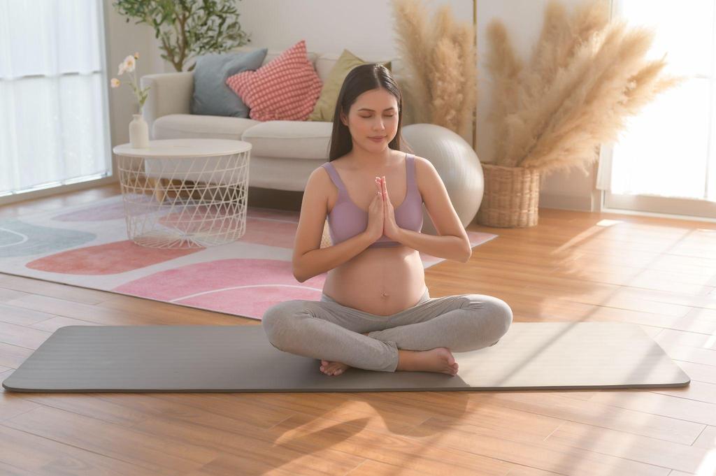 A pregnant woman in a yoga pose outdoors, promoting relaxation and wellness during pregnancy.