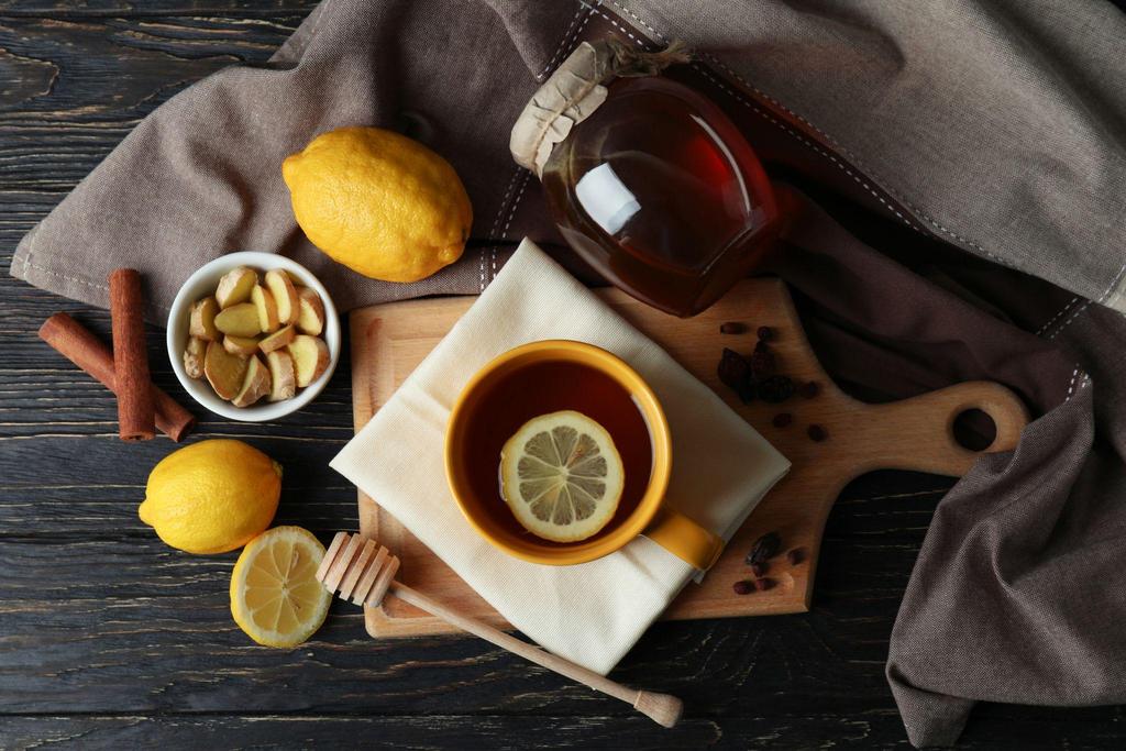 A warm Lemsip drink alongside lemon and honey, representing remedies for cold and flu during pregnancy.